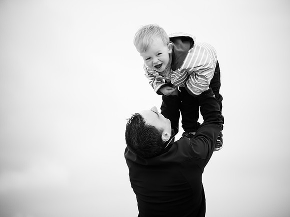 A little boy having fun with his dad at a day on the beach with celynnen Photography