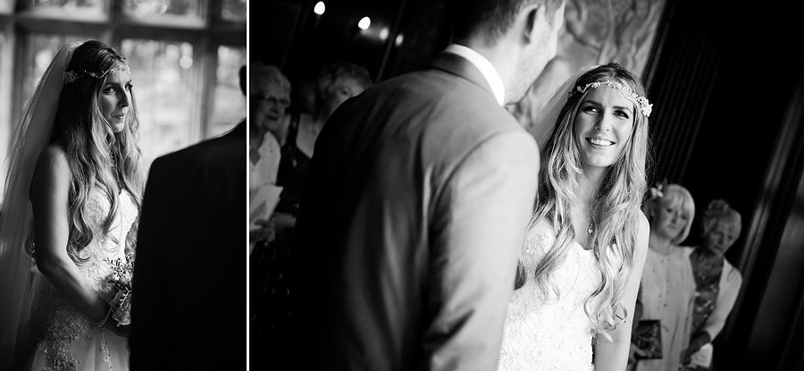 Bride smiling at her groom in the hercules hall for her wedding in Portmeirion