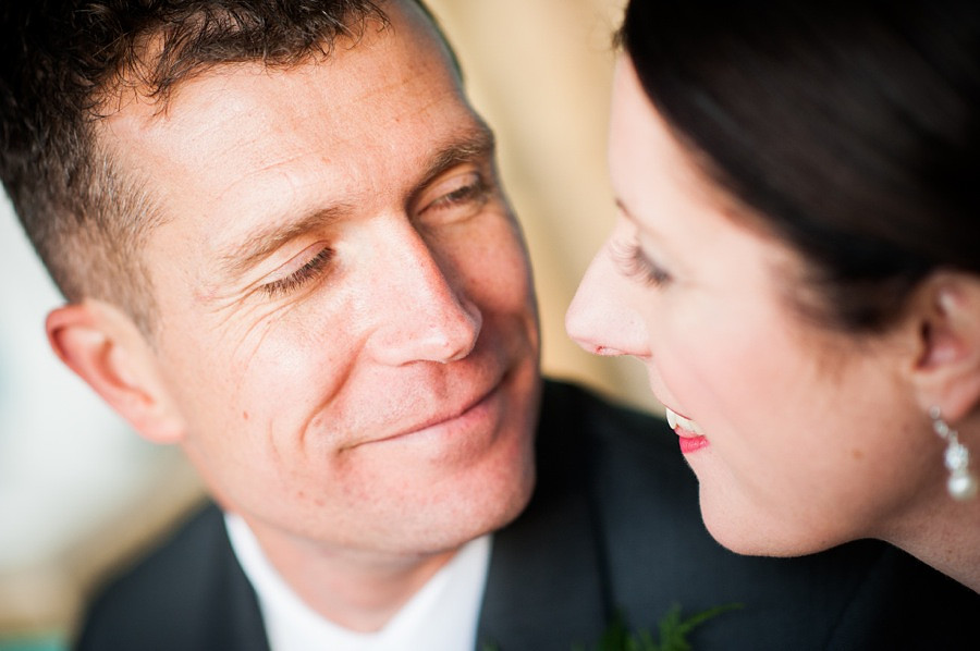 Groom smiling at Bride on Wedding Day by Photographer Celynnen Photography