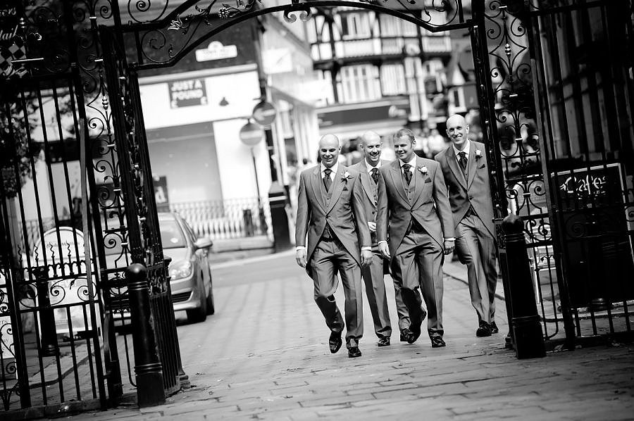 The groom and ushers walking through Wrexham town centre to St-Giles Church