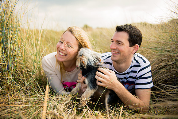 A couple and their Yorkshire Terrier enjoying a portrait shoot on Talacre Beach by Celynnen Photography for their pre wedding session