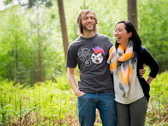 A couple laughing while enjoying a portrait photoshoot by Celynnen Photography in Delamere Forest, Cheshire