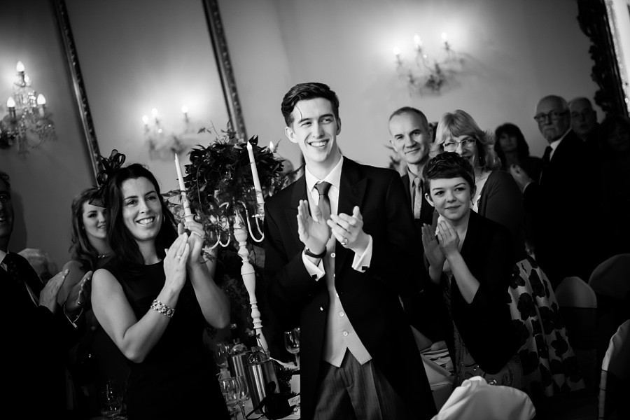Guests clapping for married couple by Photographer Celynnen Photography
