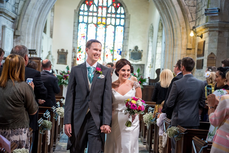 bride and groom leaving their wedding as husband and wife, at a wedding in Anglesey.