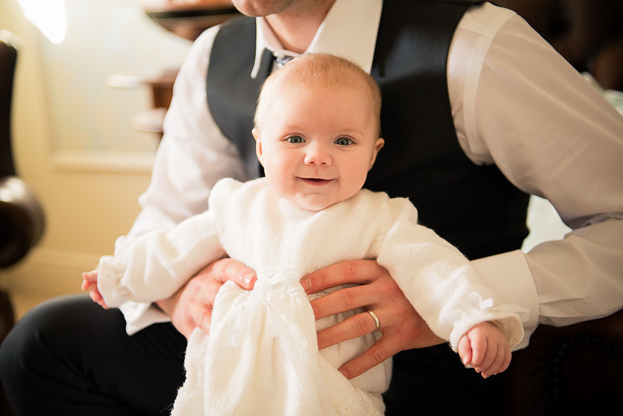 Photograph of smiling Amelia with Daddy, taken by Celynnen Photography at Trearddur Bay Hotel.