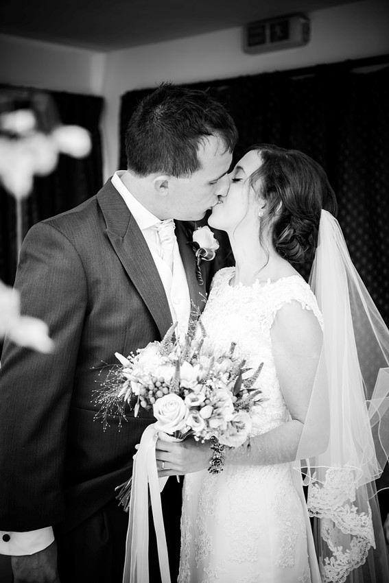 Bride and Groom Kissing at their Wedding by North Wales Wedding Photographer Celynnen Photography