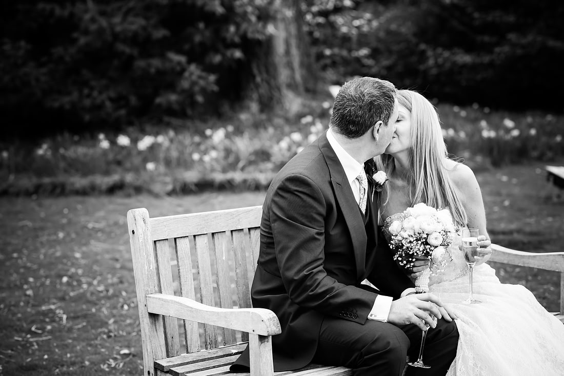 Black and white image of the bride and groom sharing a kiss in the grounds of the Taplow House, Buckinghamshire