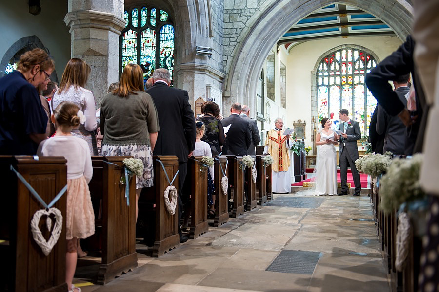 Bride and groom about to leave their wedding ceremony as husband and wife at a wedding in Beaumaris