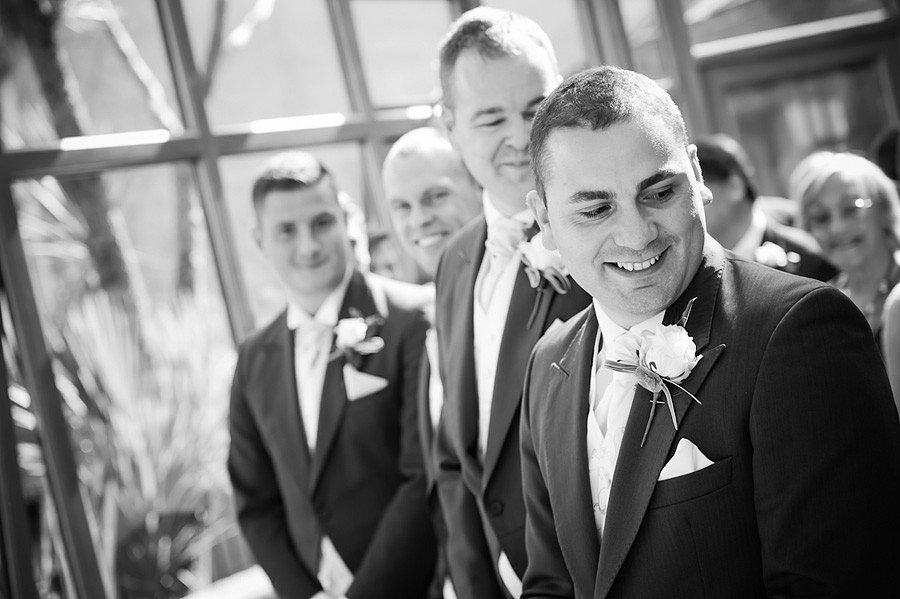 the groom during the wedding ceremony at Seiont Manor, Caernarfon. Wedding photographer: Celynnen Photography