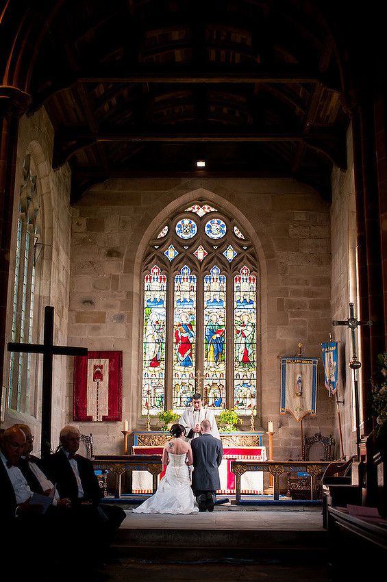 Photo from the back of a church during a wedding ceremony.
