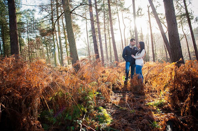 Colourful picture of a couple standing in a forest for their pre wedding photo shoot.