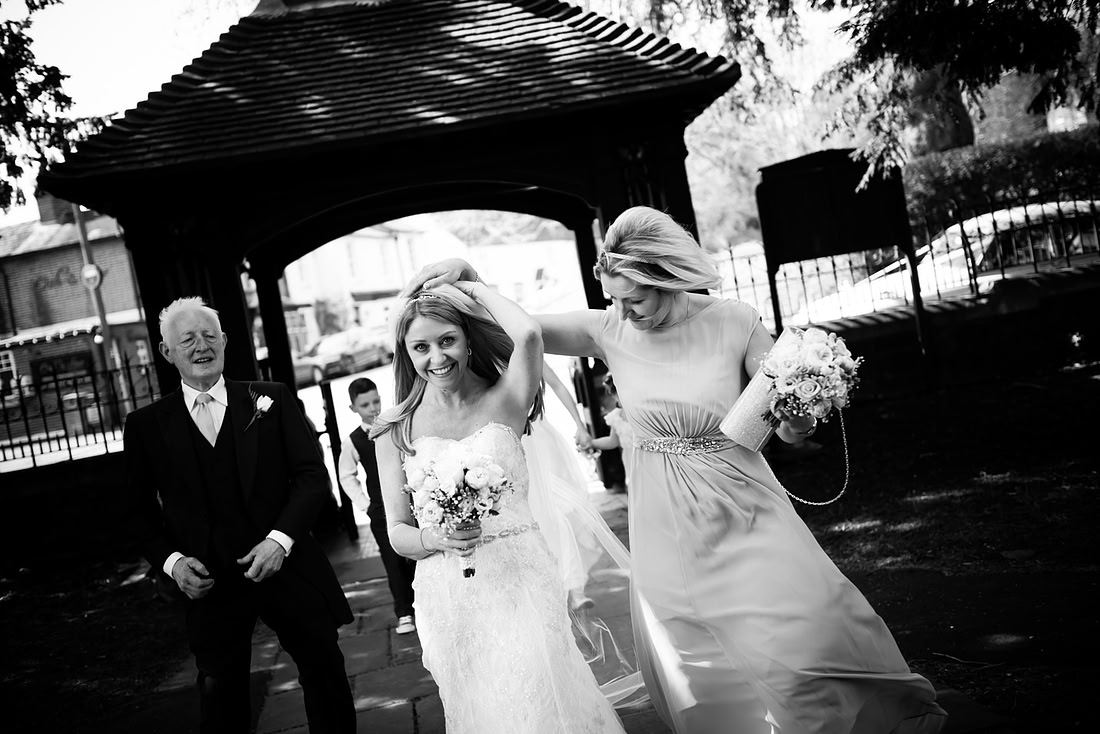 Black and white image of the bride arriving at the church for a wedding in Buckinghamshire.