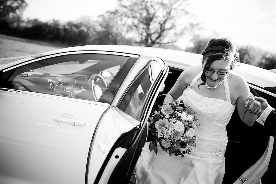 Bride arriving in a car to her wedding venue.