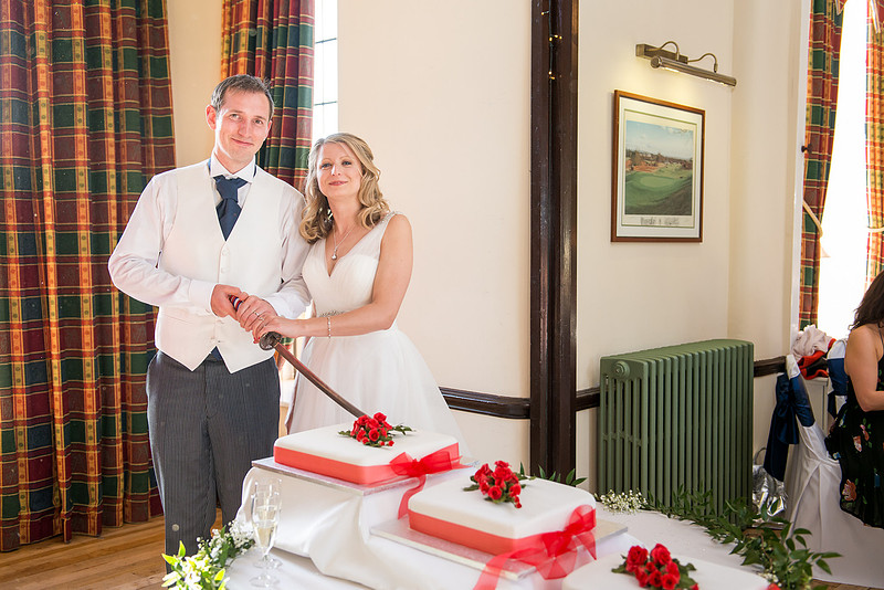 Image of the bride and groom cutting the cake at their wedding in Davenham.