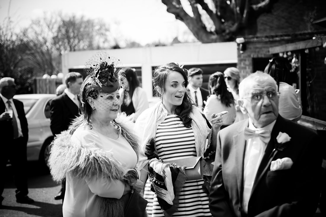 Black and white image of guests arriving at a wedding in Buckinghamshire.