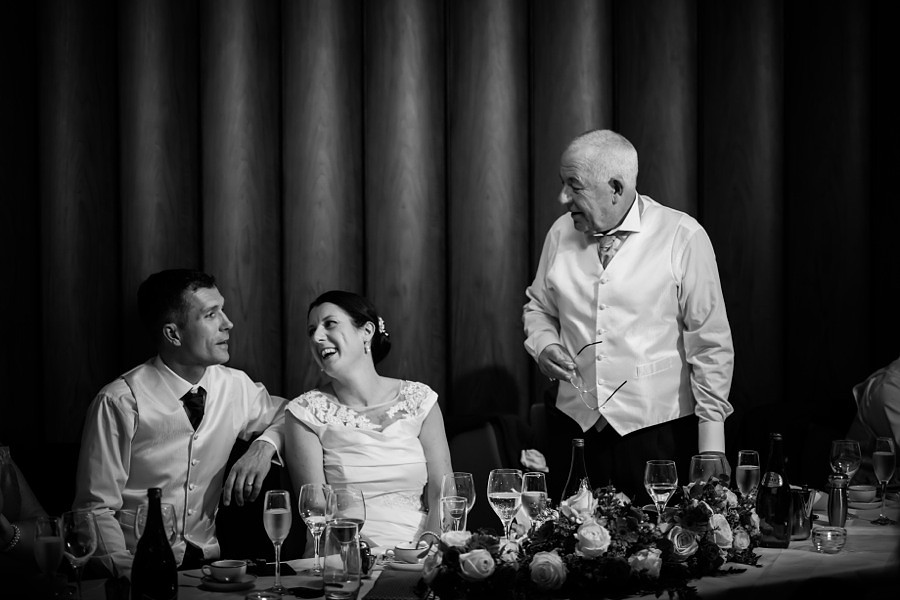 Bride enjoying herself during her father's speech at her wedding in Portmeirion.