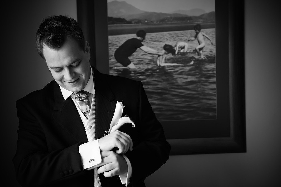 Black and white image of the groom getting ready before the wedding in Portmeirion.