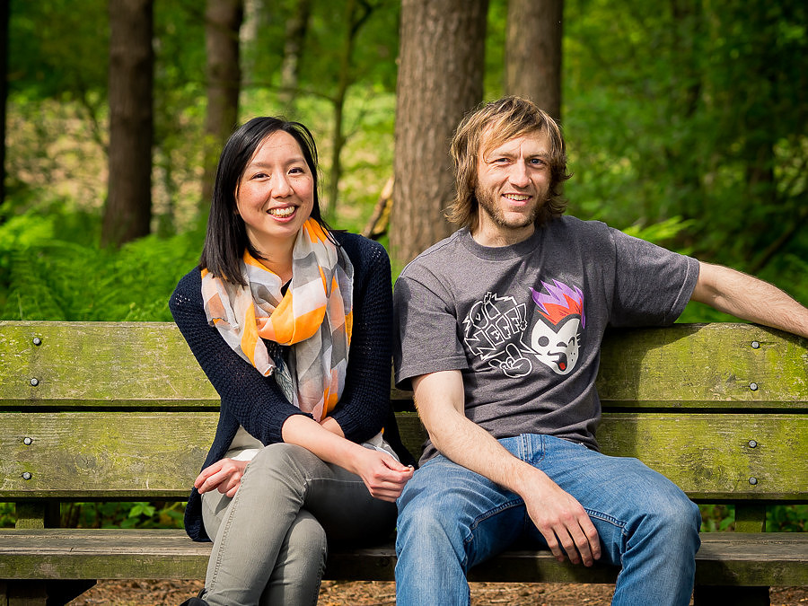 Photograph of Lisa & Dan sitting on a bench in Delamere Forest. Celynnen Photography. Pre Wedding Shoot. Dan & Lisa