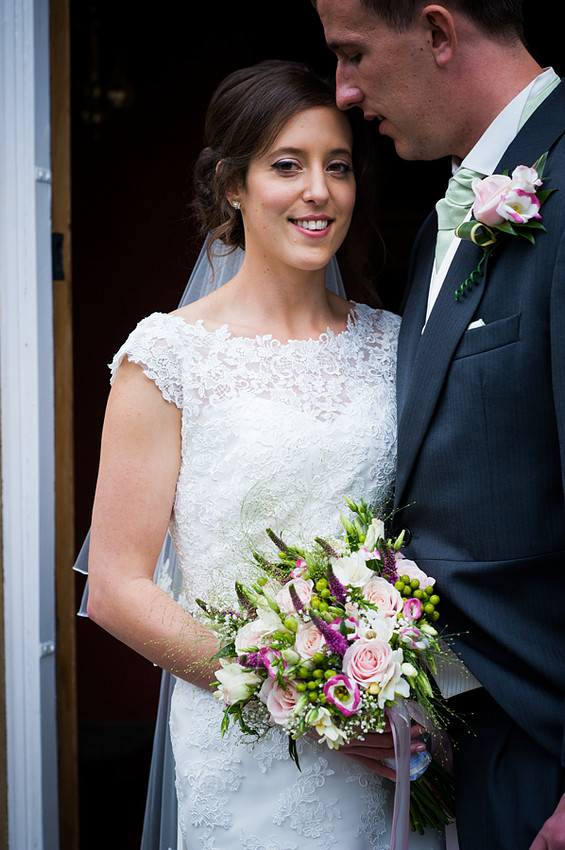 Smiling Bride Next to her Husband by North Wales Wedding Photographer Celynnen Photography