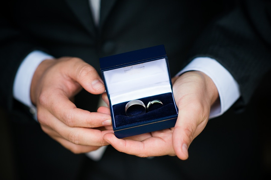 Groom holding the wedding rings at Tre-Ysgawen