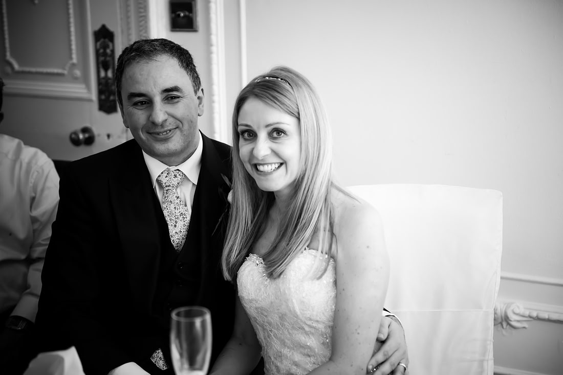 Black and white image of the bride and groom after the speeches at their wedding at Taplow House, Buckinghamshire.