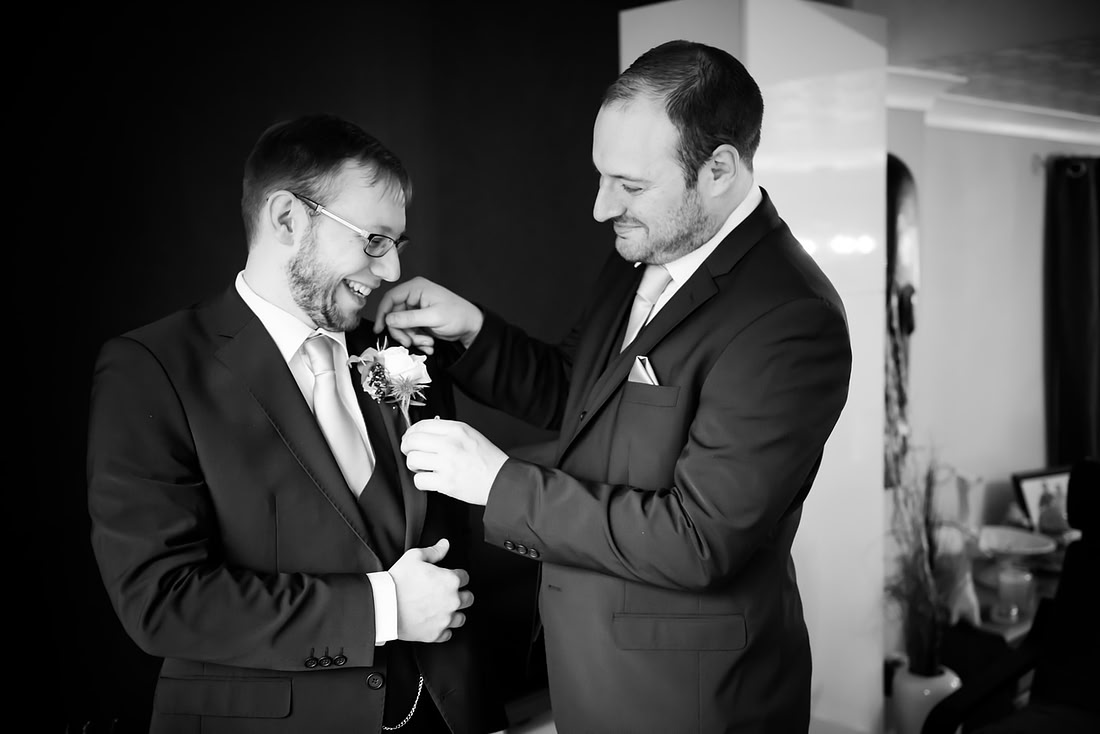Black and white image of the groom and one of his ushers getting ready for a wedding at Mere Brook House.