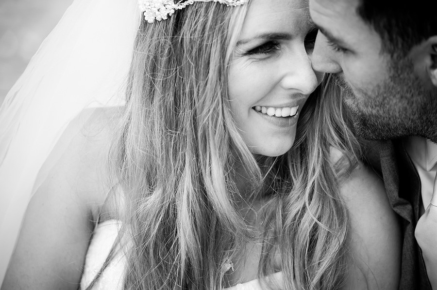 Bride and groom, close together in Portmeirion. Wedding speeches in Portmeirion. Wedding photographer: Celynnen Photography