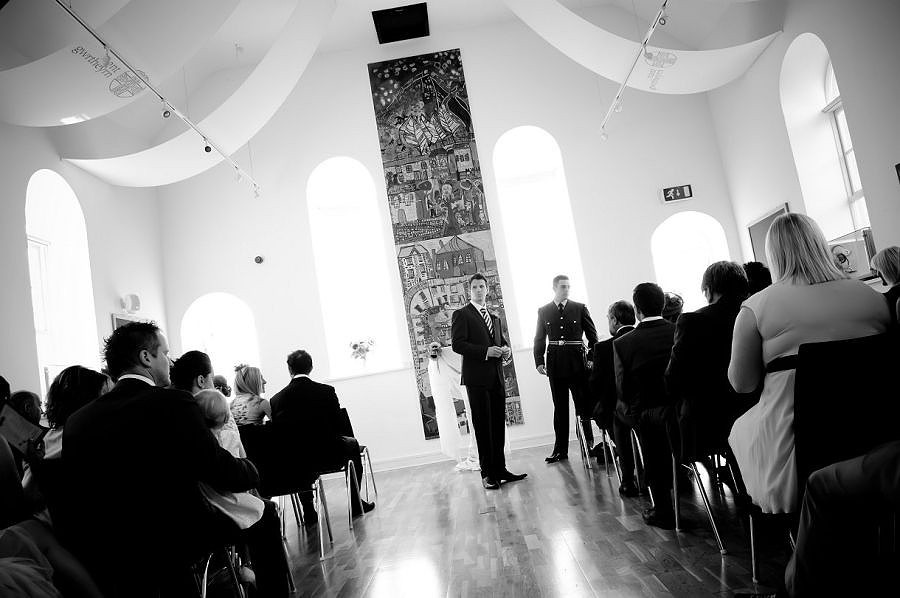 The groom waiting in the chapel before the wedding at Nant-Gwythern by Celynnen Photography