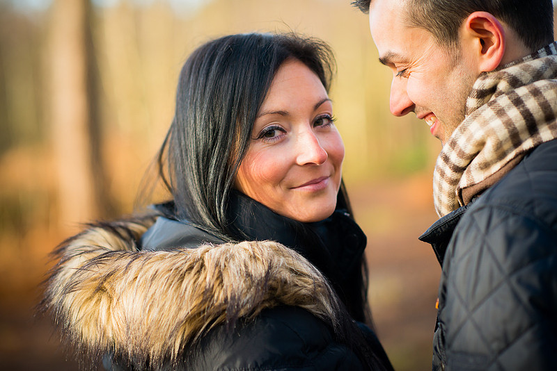 Photo of woman glancing back to the camera during a pre wedding shoot in Delamere Forest.